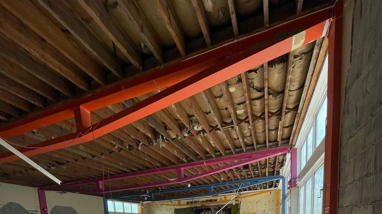 Exposed structural steel beams beneath timber joists during building works